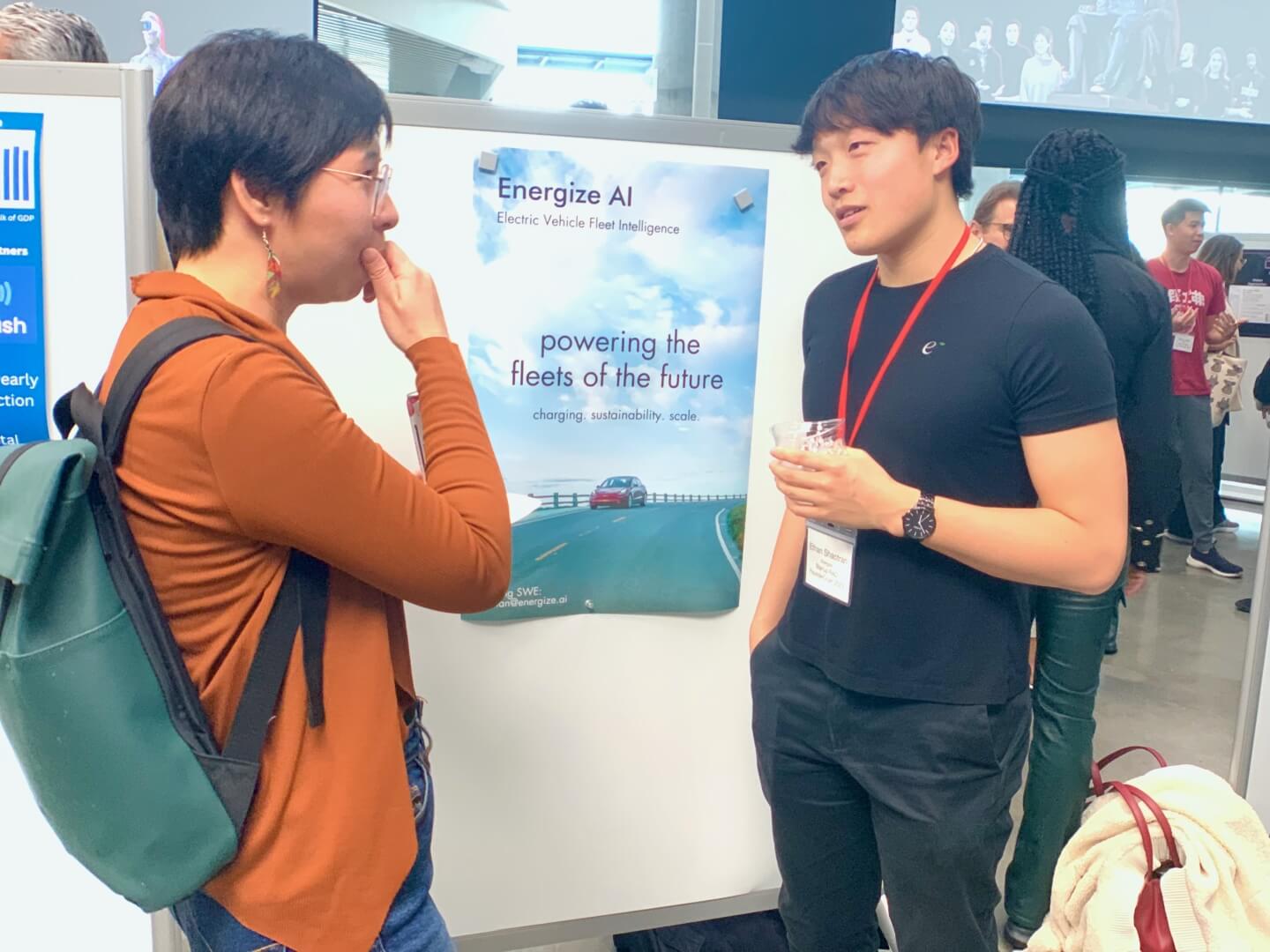 Ethan Shaotran with a poster for the start-up "Energize AI"