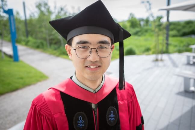 Harvard SEAS student Yaowei Li wearing his crimson regalia