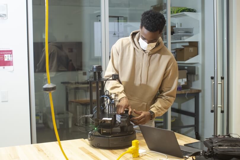 Emeka Ezike adjusts his robot