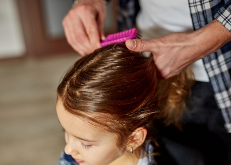 man brushing child's hair