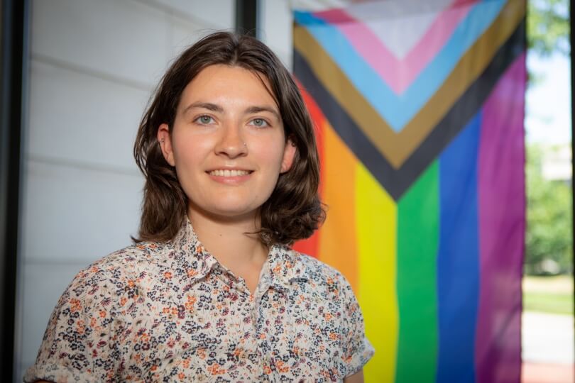 Ashley Cavanagh with Pride flag at Maxwell Dworkin