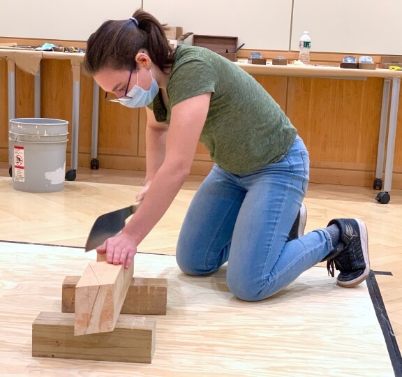 Kade Kelsch works with a hand saw