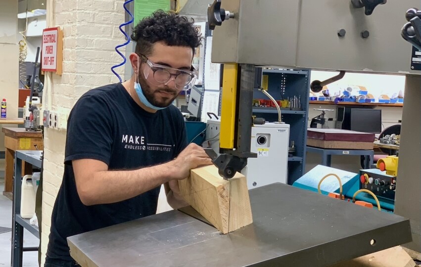 David Andrade uses a band saw