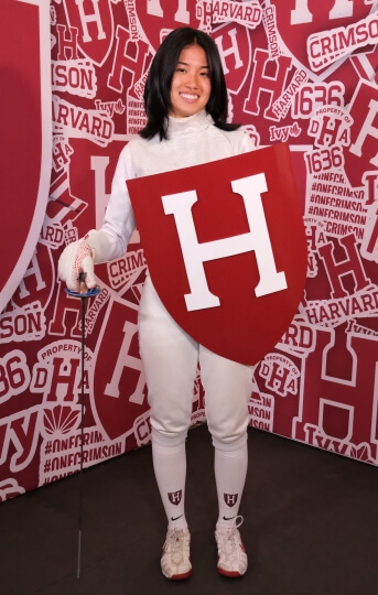 Cynthia Liu, A.B. '23, with her fencing sword and Harvard shield