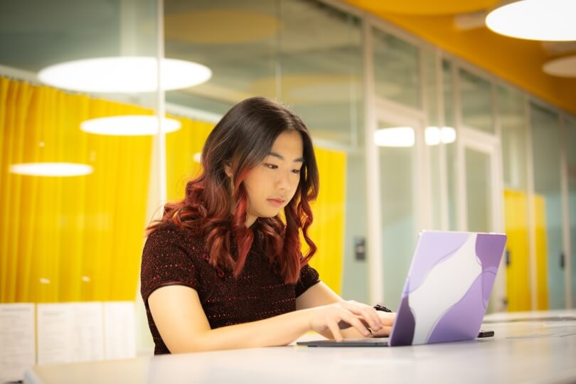 Catherine Yeo, A.B. '23, working on her laptop computer 