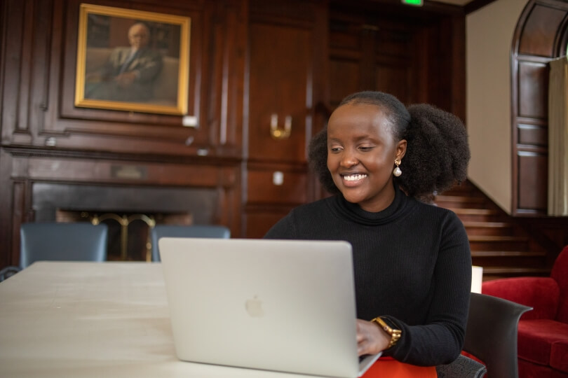 Chepchumba Choge, A.B. '23, working on a laptop computer