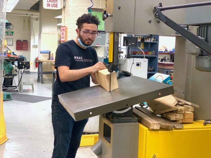 David Andrade uses a band saw during a Japanese wooden boatbuilding workshop