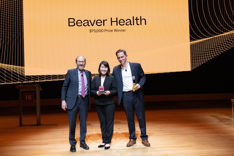 Harvard SEAS alumna Emily Wang standing between interim president Alan Garber and Harvard Innovation Labs director Matt Segneri