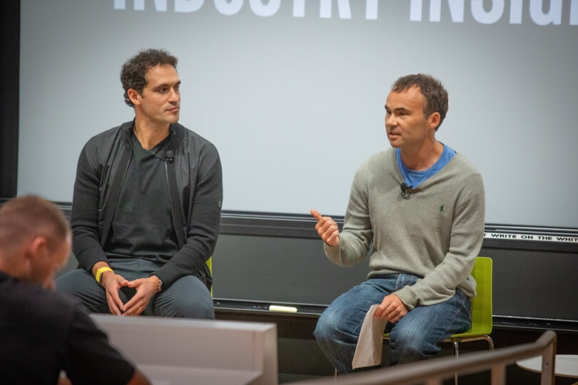 Harvard alum and WHOOP founder Will Ahmed with SEAS professor Conor Walsh chatting together at the Science and Engineering Complex