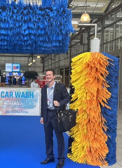 Harvard SEAS alum Alan Nawoj, S.M. '04 next to car wash brushes