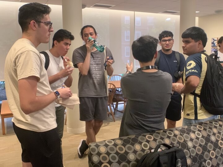 A group of Harvard students standing in a circle