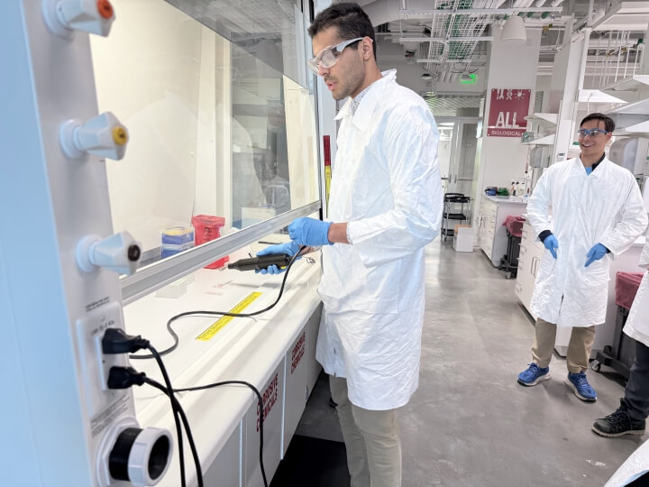 Harvard SEAS student Nureldin Mohamed working under a chemical hood