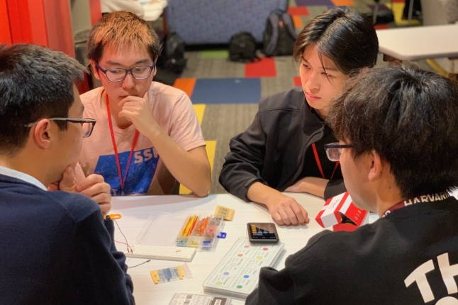 Four DexteriKey members work on their project