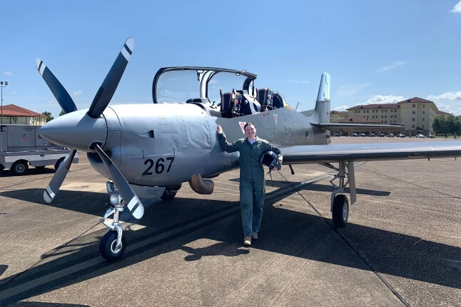 Harvard SEAS student Faith Schmidt in front of a propeller plane